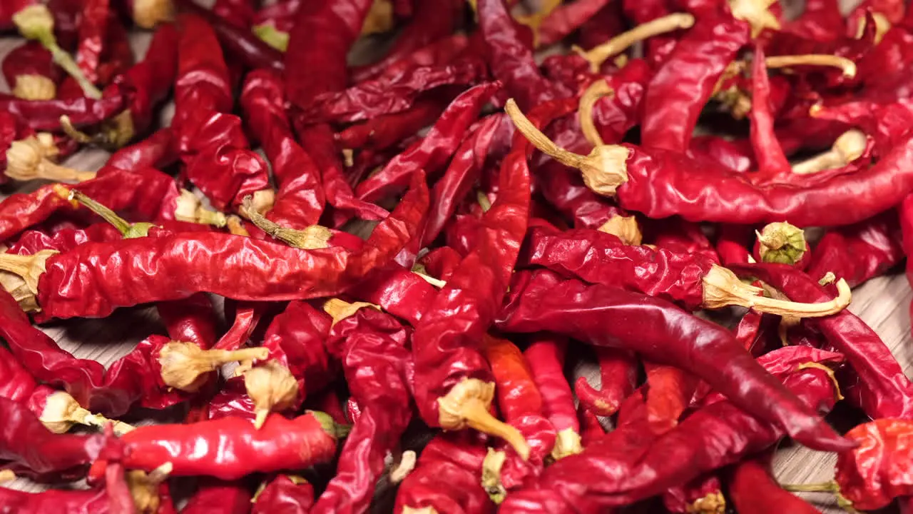 Chili peppers rotating on wooden background