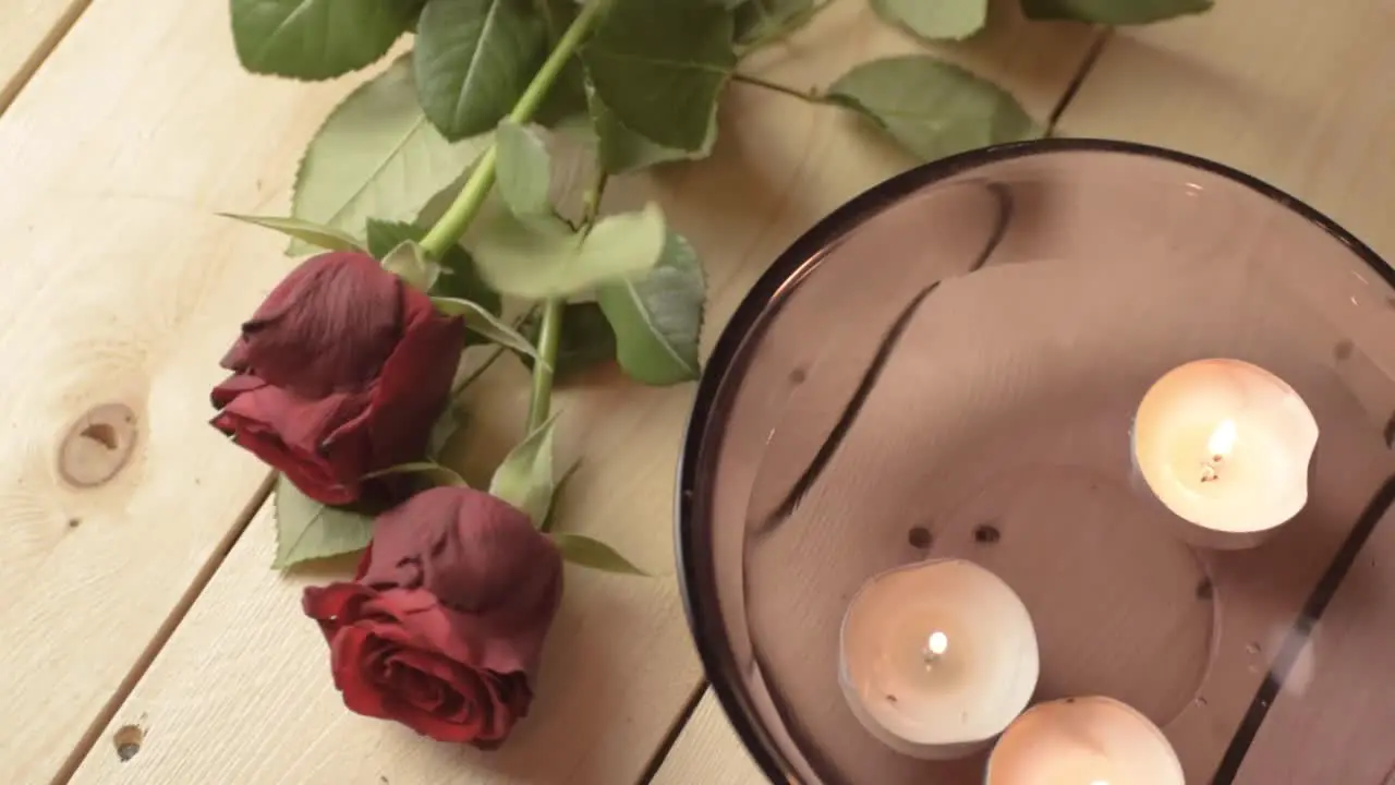 Floating tea light candles with red rose for romantic evening