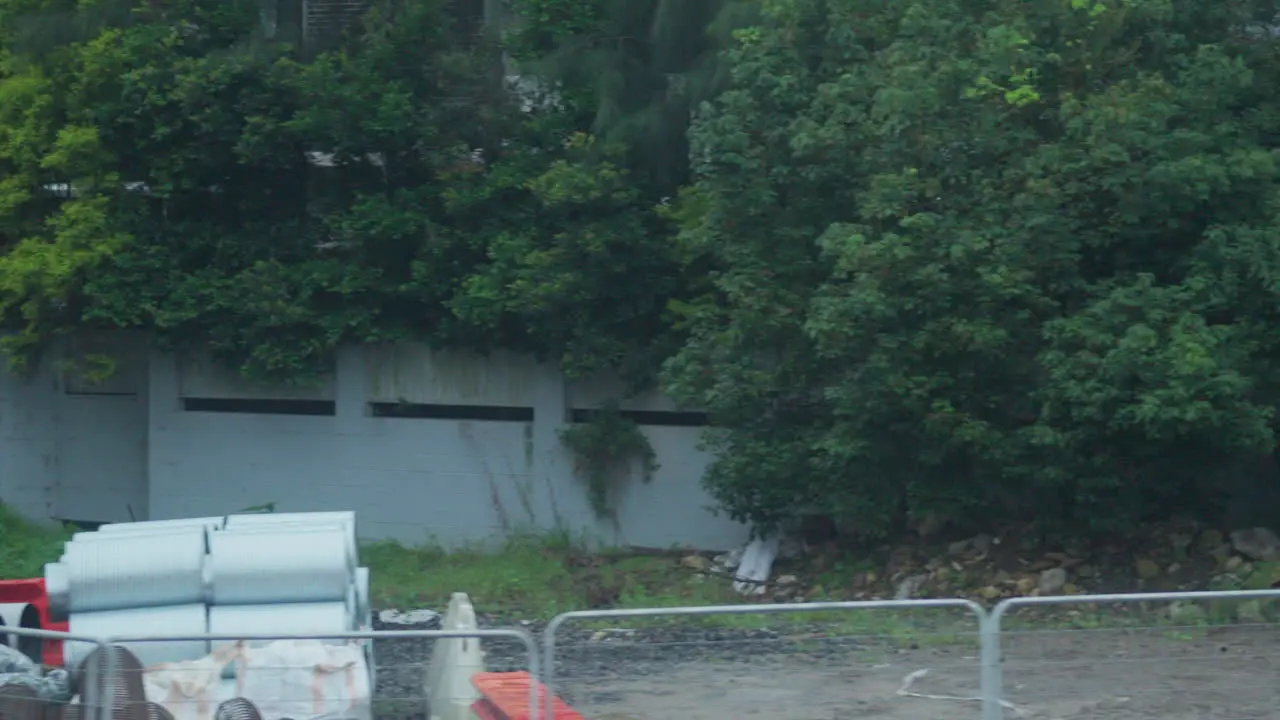 Filming out of a train window during the early dawn passing a construction site in Sydney Australia