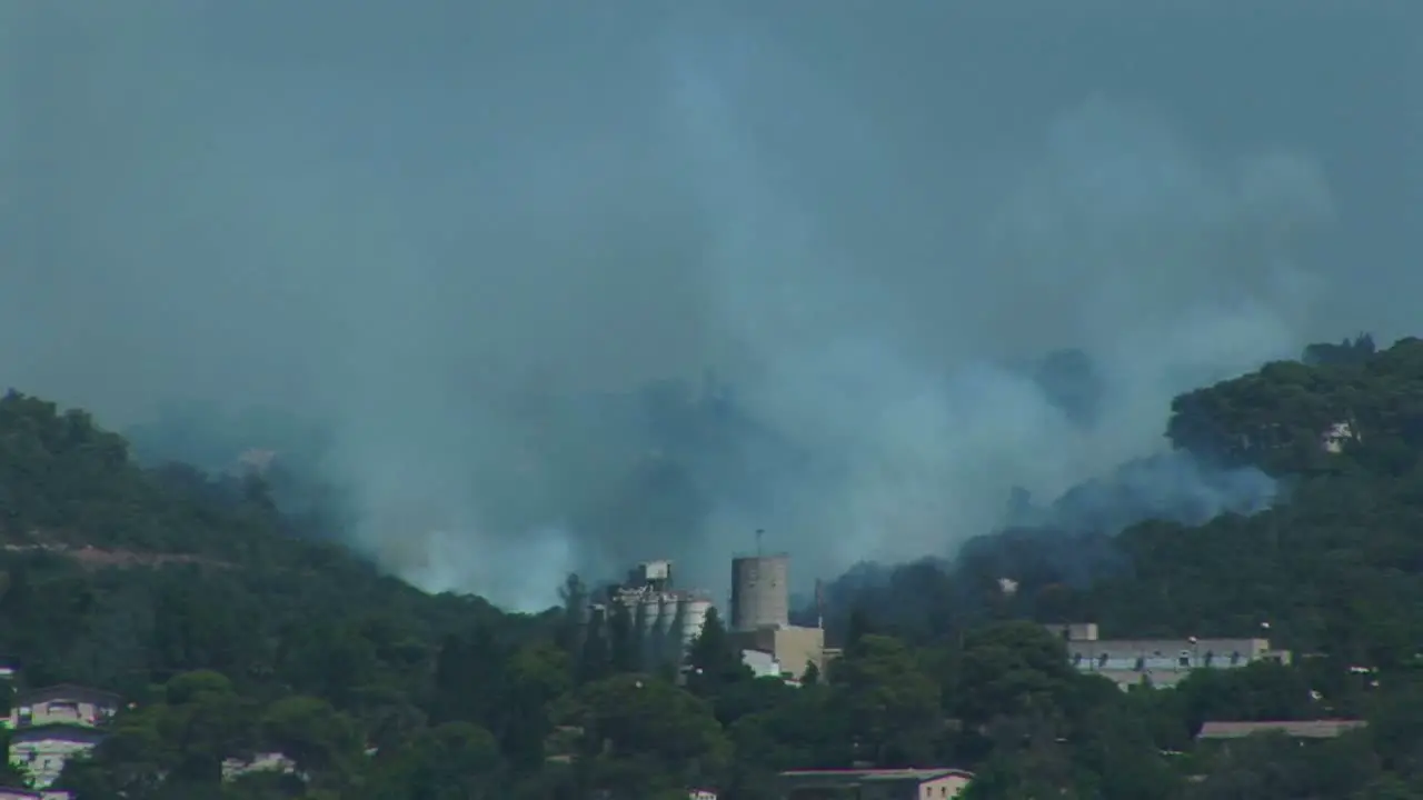 Plumes of smoke rise from the mountains around Haifa Israel during the Israel Lebanon war