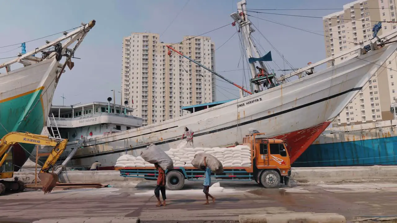 Long Shot of Men Walking Past Boat