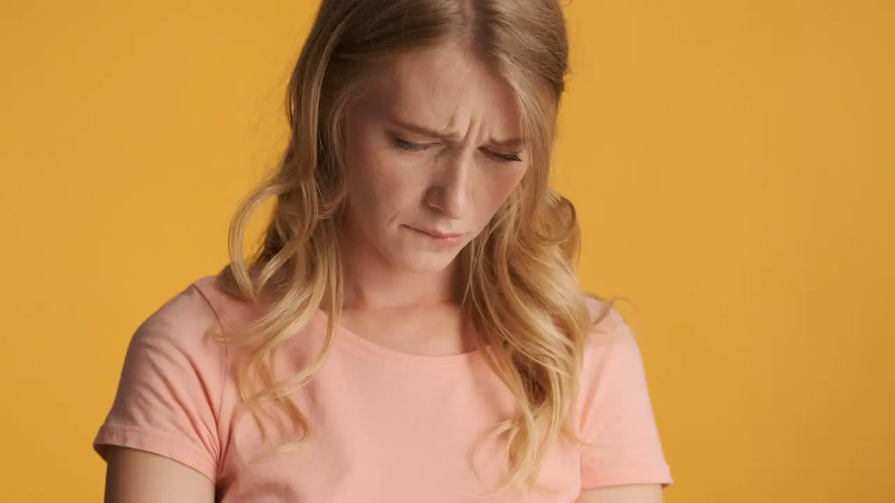 Caucasian woman using smartphone and getting sad