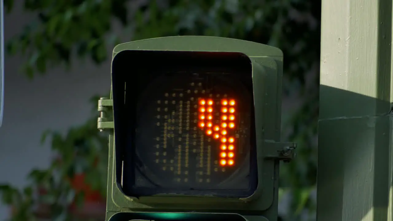 A traffic light countdown from ten to red man figure