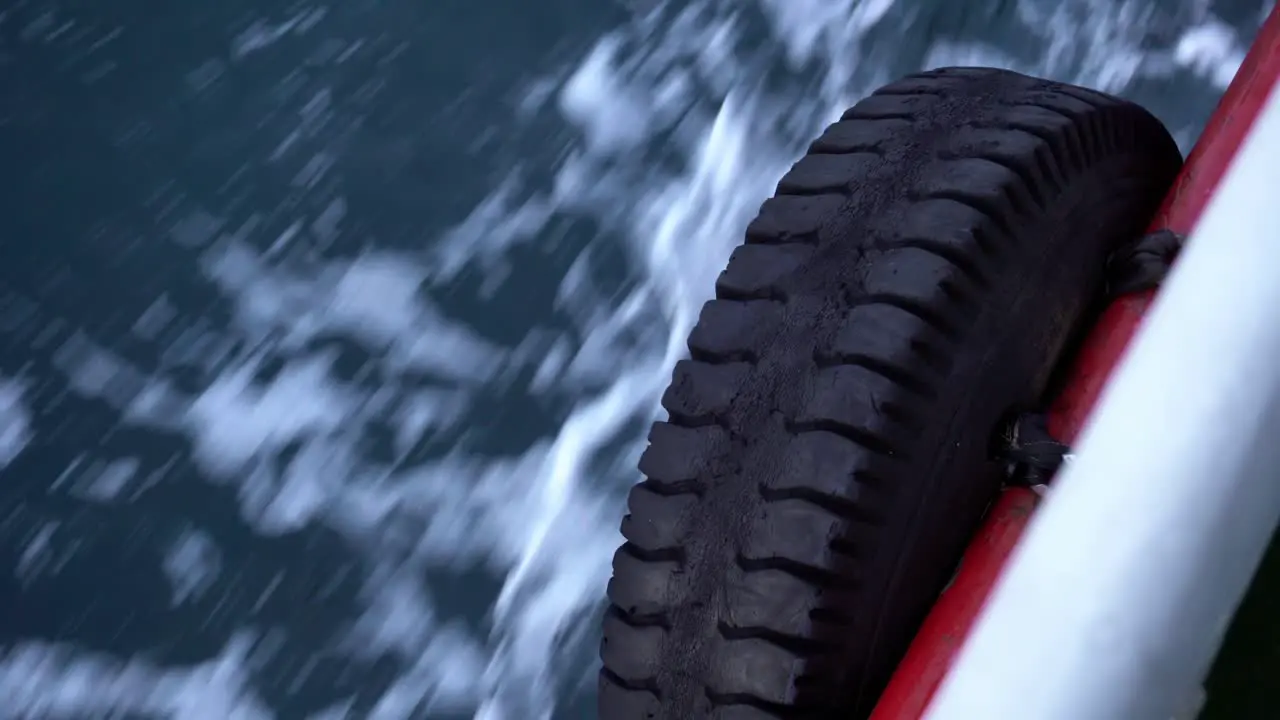 Car tire on the side of the boat while moving over the sea in Istanbul