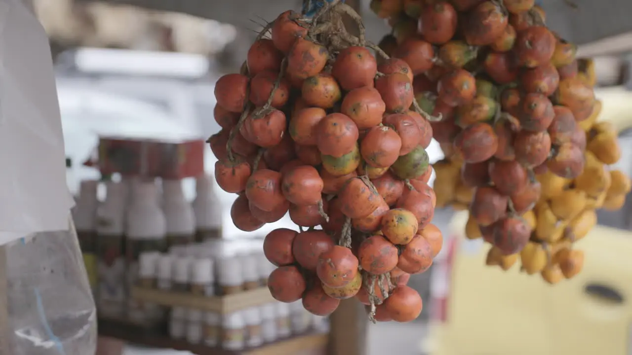 Slow motion footage at a market of a bunch of tomatoes grouped together at a vegetable stand