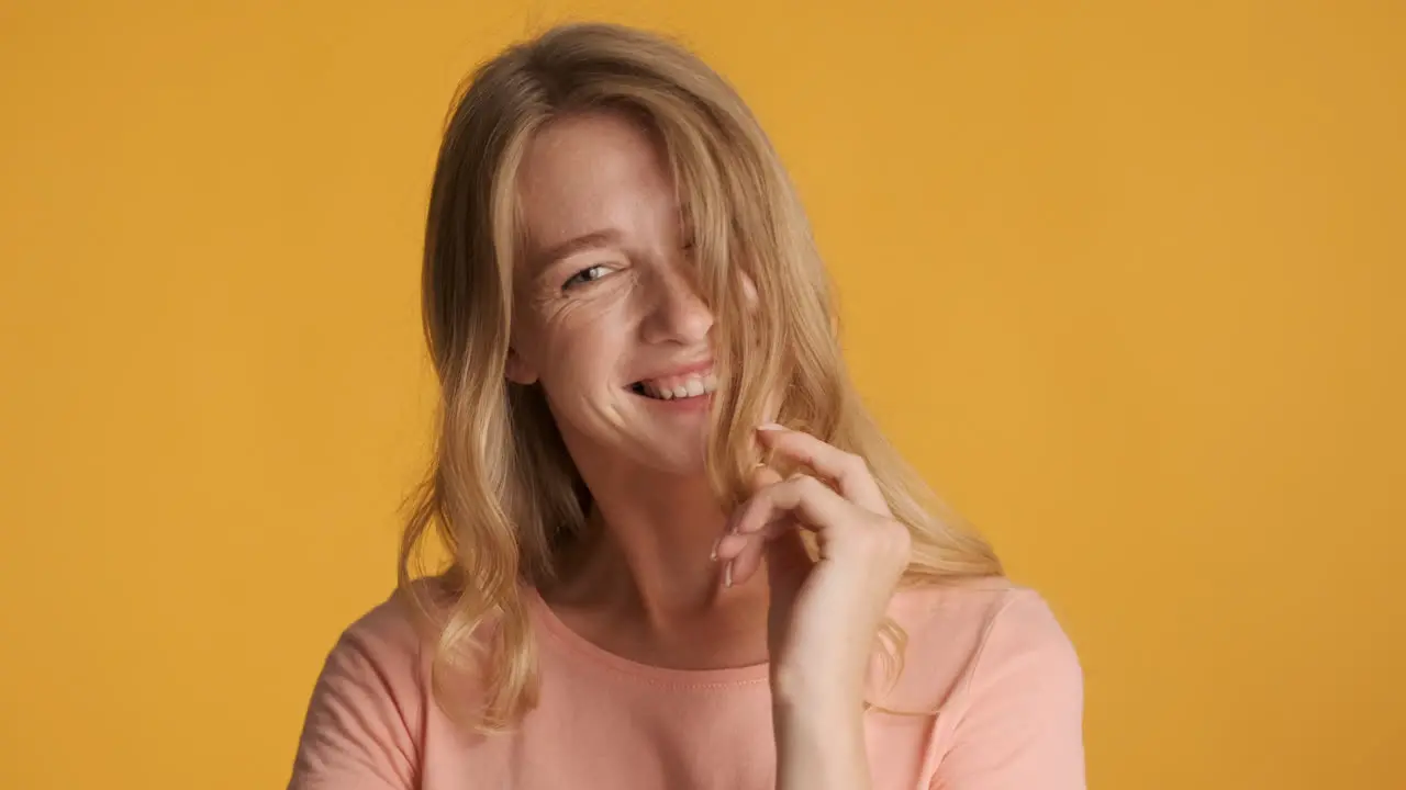 Caucasian woman showing flirting gestures on camera