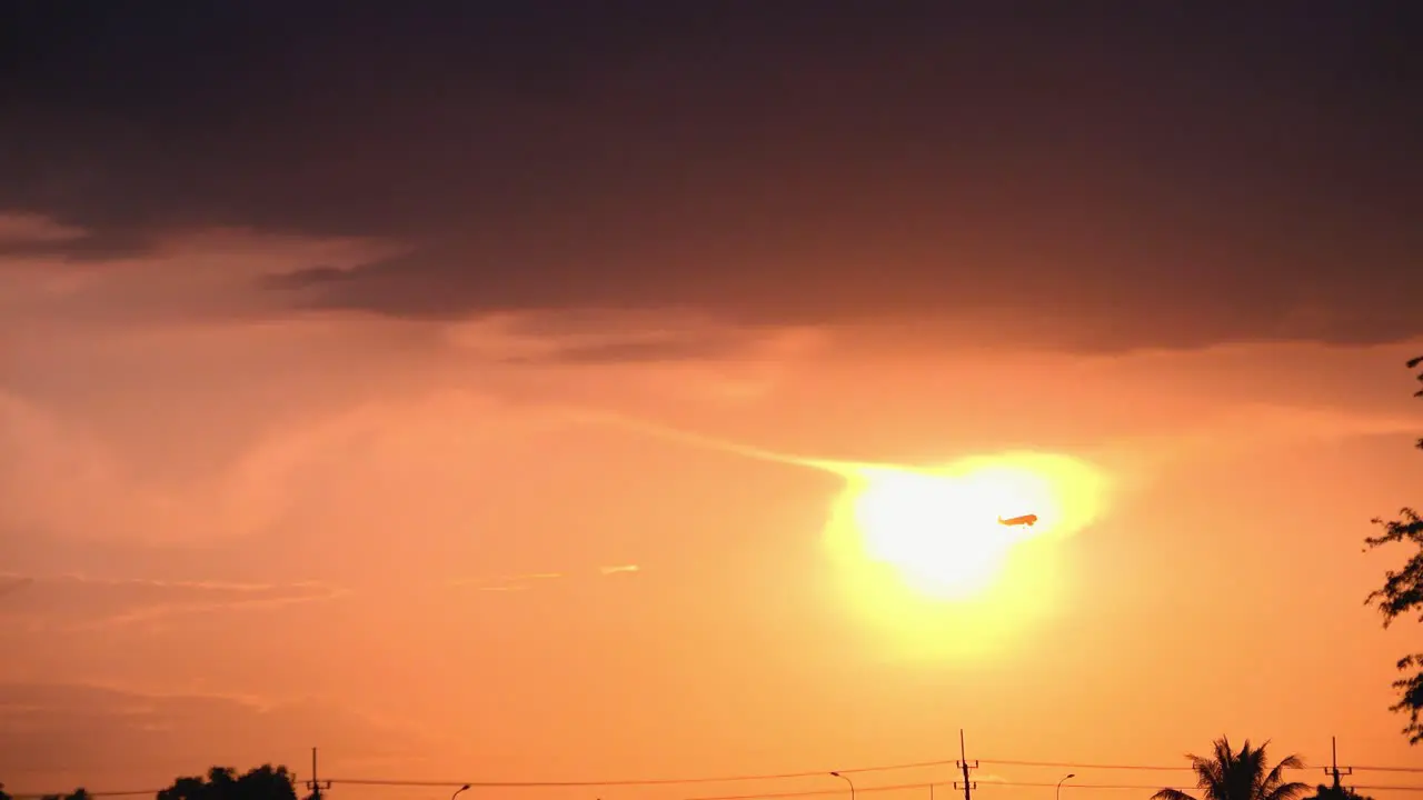 Silhouette of Airplane Going Past Sun While Ascending