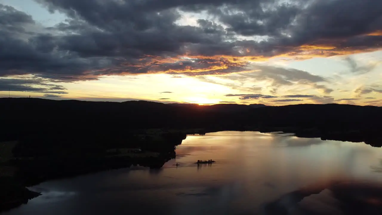 Flying above a lake in Norway with a fantastic sunset on the horizon