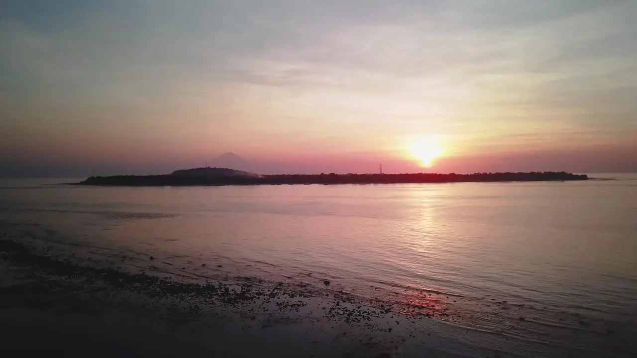 Sunset view of a volcano from a tropical beach