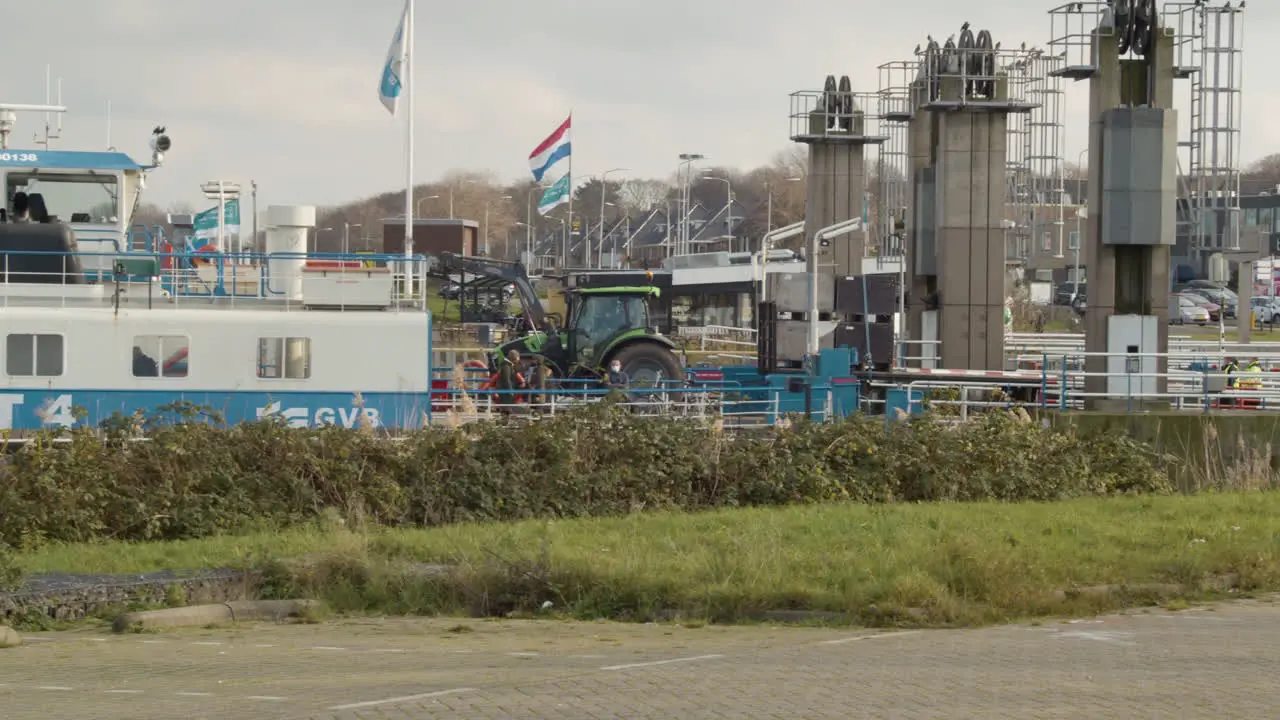 Tractor boarding docked Amsterdam Ferry in the Netherlands