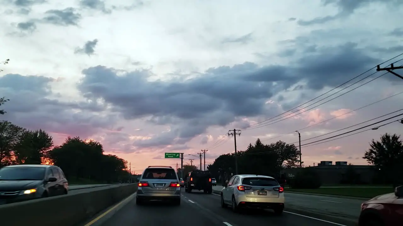 Beautiful timelapse of sunset with clouds while in traffic timelapse