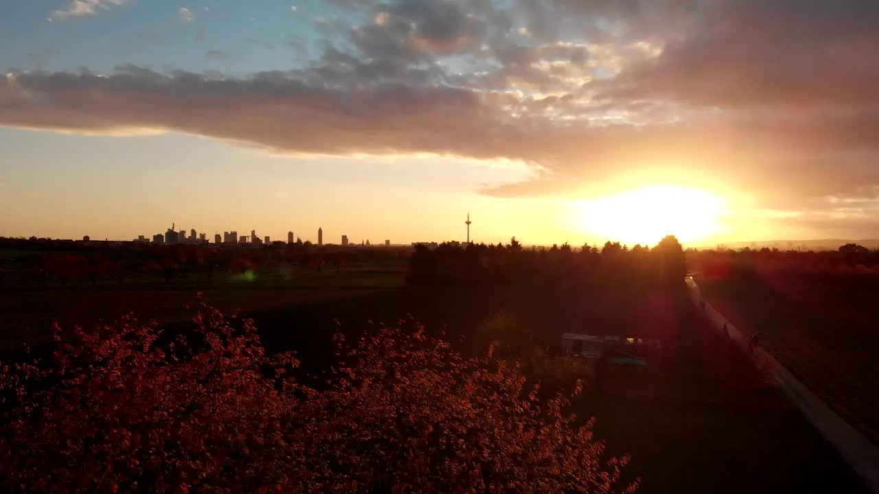 A skyline  fields and suburbs are slowly revealed