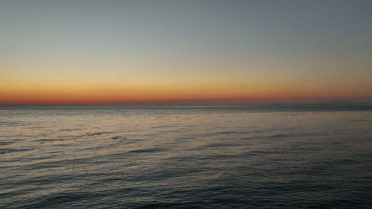 Aerial view of the sun setting over the Pacific Ocean