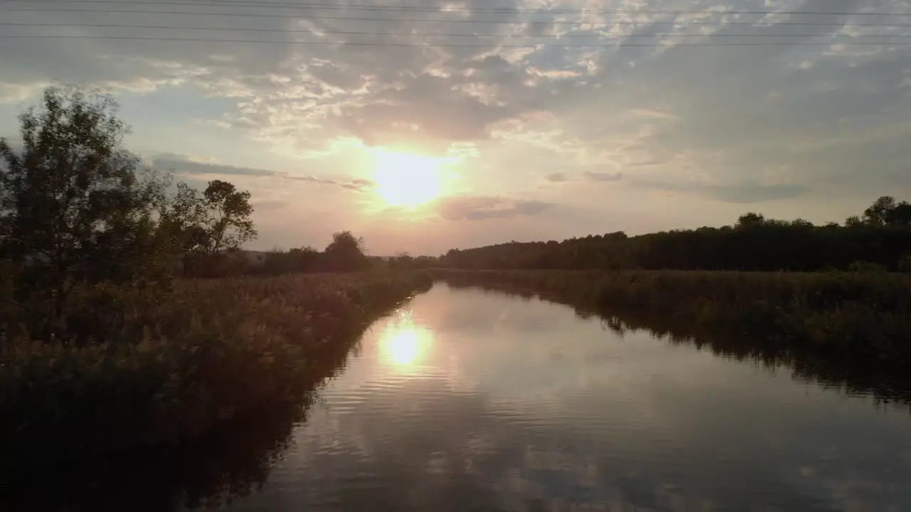 Low drone shot close to the river under the high voltage wires