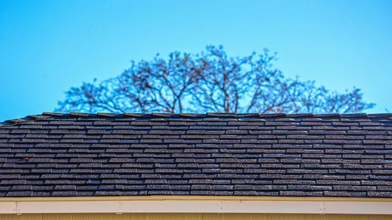 Ice and snow melting off a roof as the sun rises time lapse