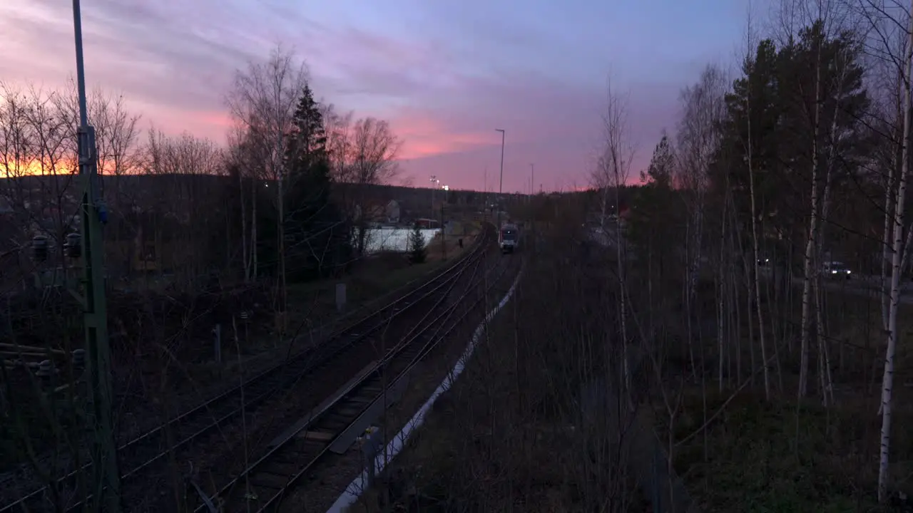 Train Arrives In Rural Countryside During Sunrise