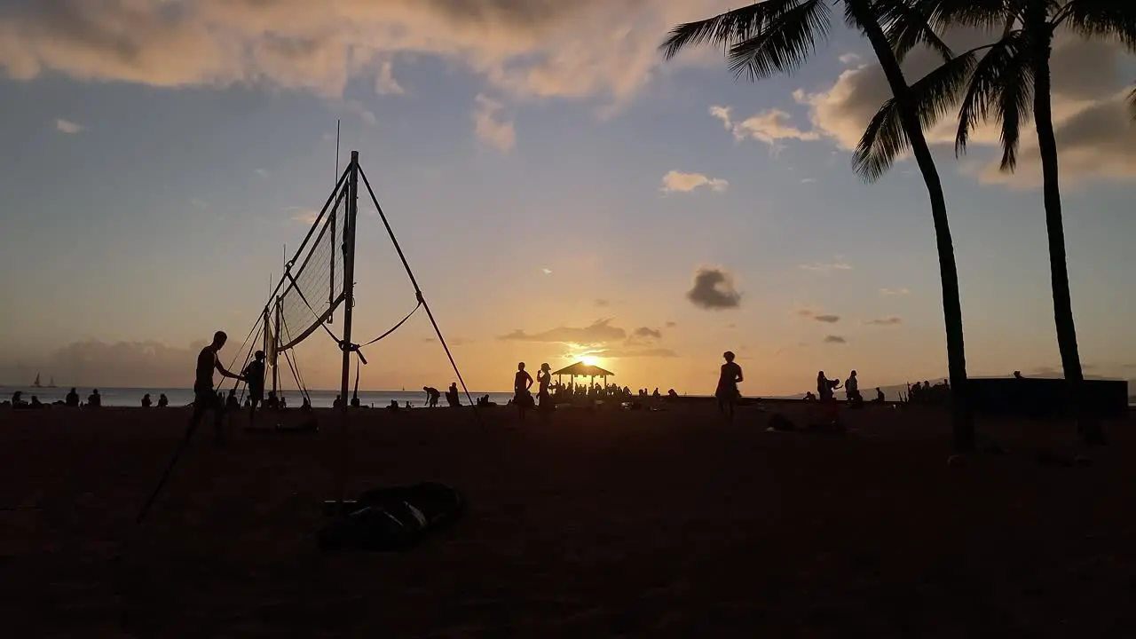 Time lapse of Waikiki sunset with volleyball playing in silhouette