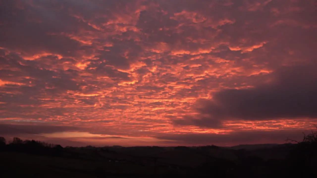 Time lapse of a beautiful sunset and cloud formations over hillside farmland at Nether Heage in Derbyshire