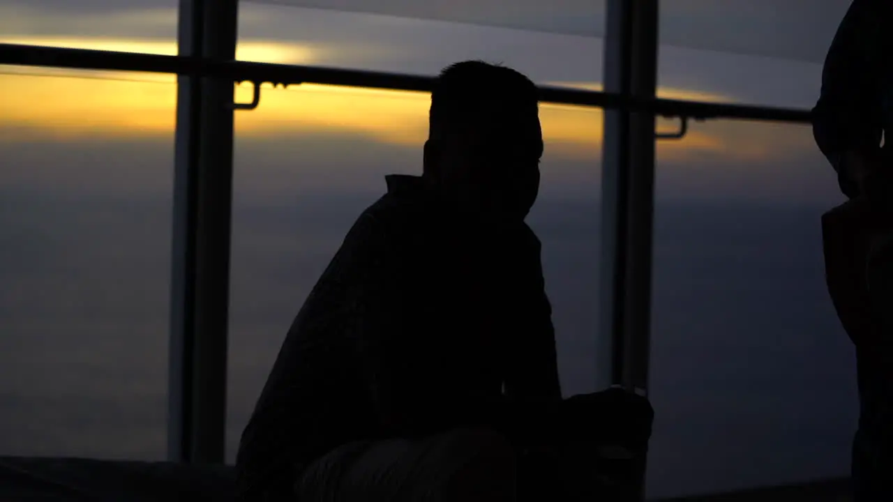 One man setting in cruise at sunset silhouette