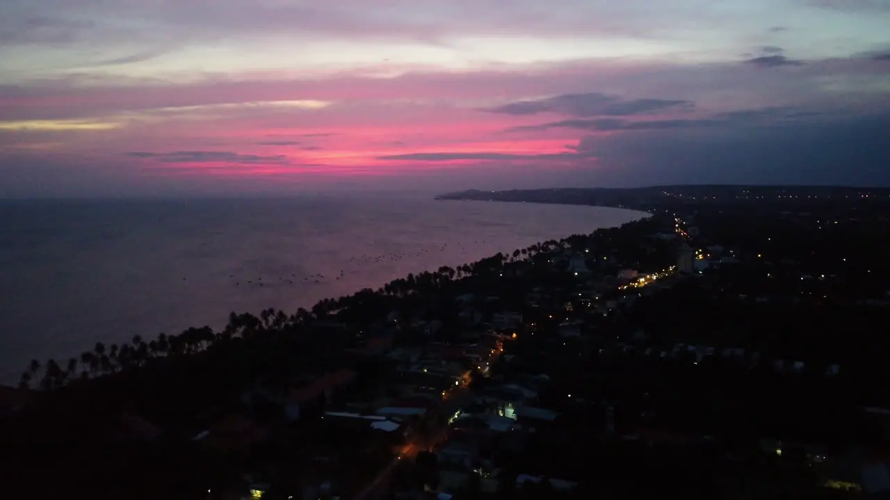 Pink glow over horizon during blue hour