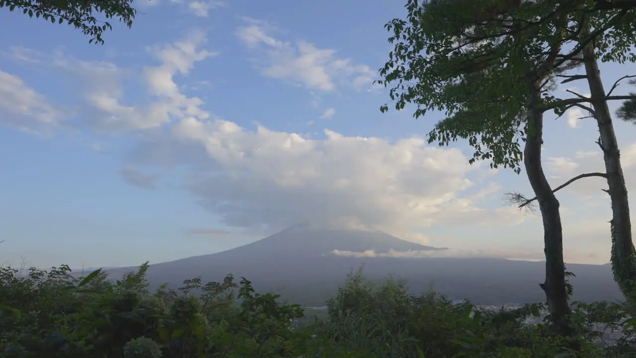 A captivating daytime timelapse unveils Fuji mountain crowned by a colossal cloud