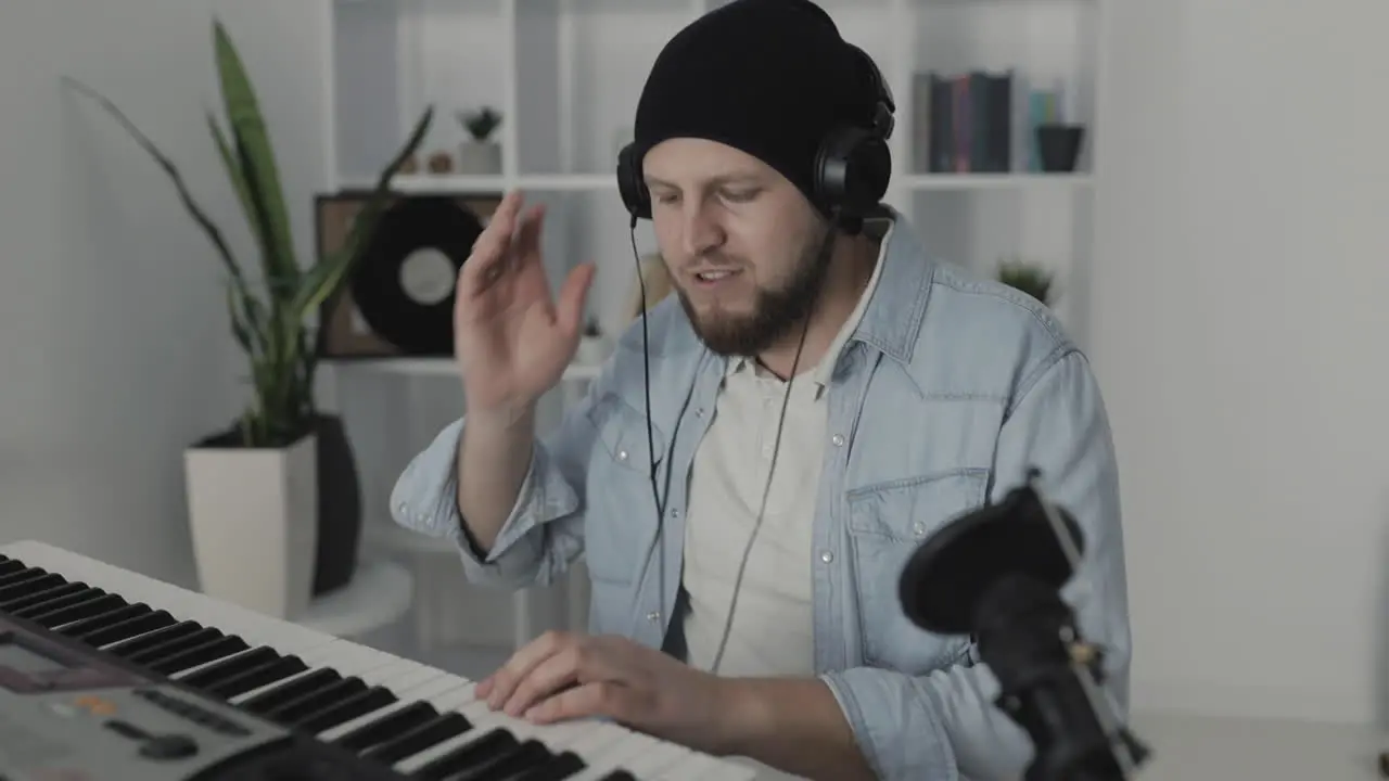 Youn Man Musician Singing And Playing Electric Keyboard At Home