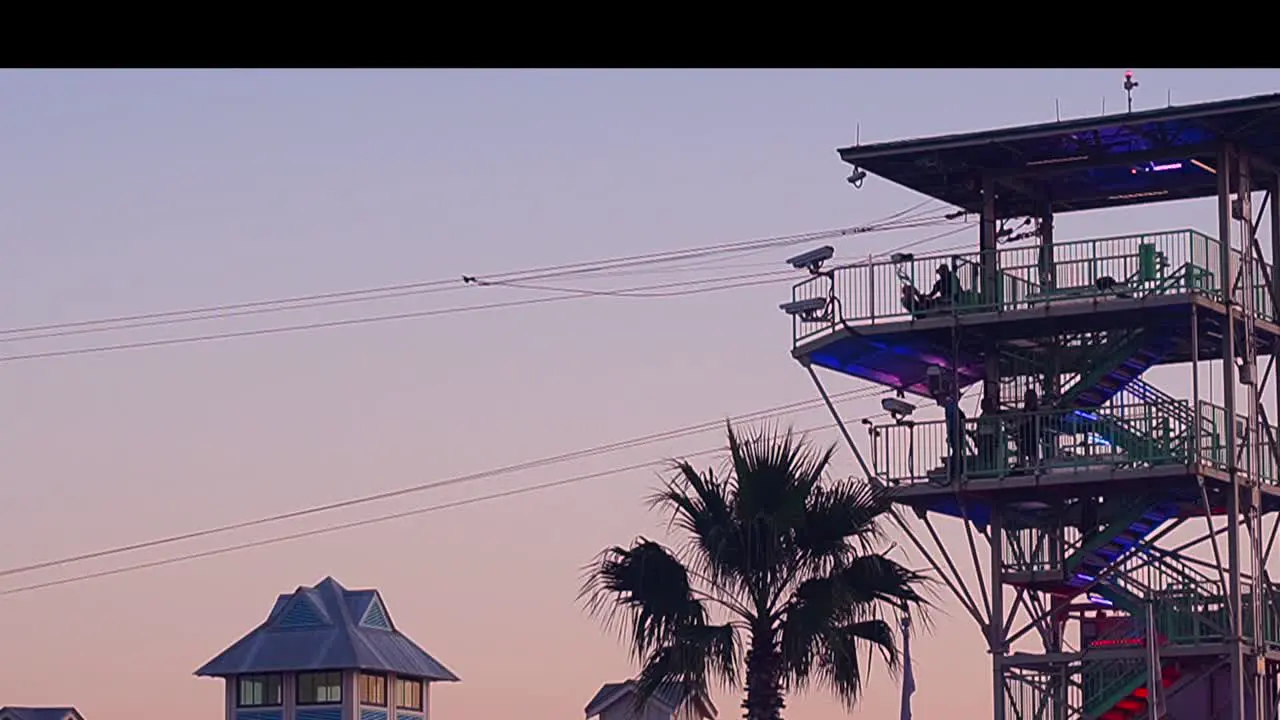 Zip lining at sunset in a touristy area in a harbor