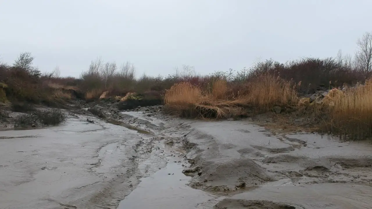 Dried river bed in aerial low altitude drone truck shot