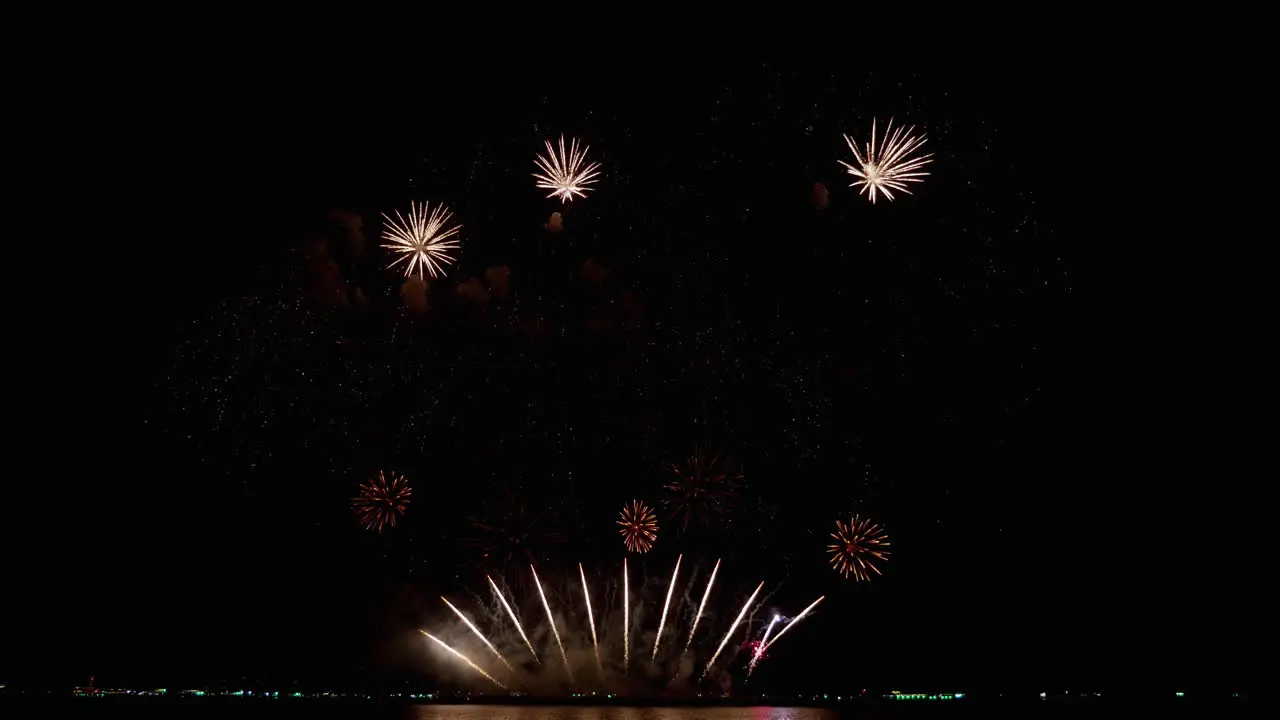 Starts with three rockets followed by silver mushroom explosions then high altitude star-like explosions Pattaya International Fireworks Festival 2023 Thailand