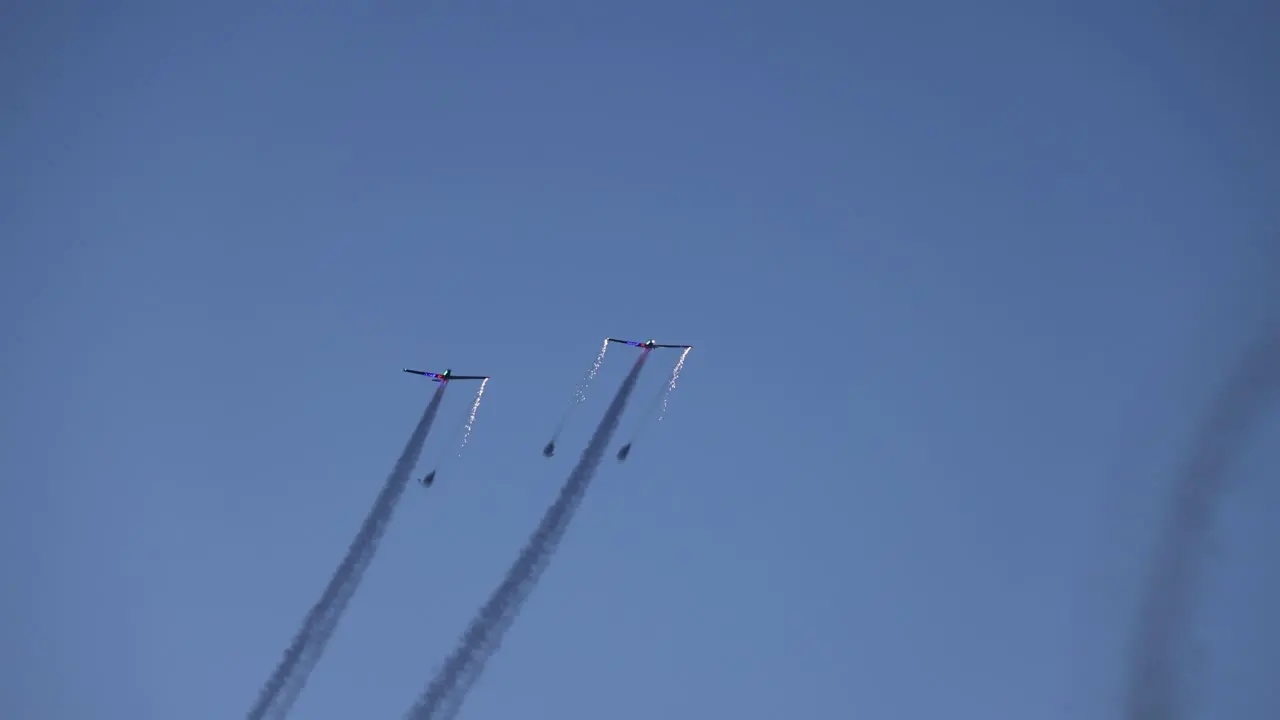 tandem pyrotechnic aircrafts starting their display with sparks and fireworks