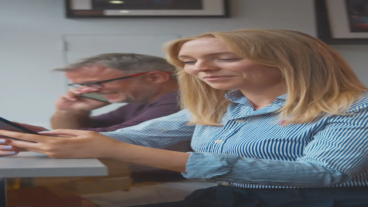 Vertical Video Of Customers In Coffee Shop Window Browsing And Making Calls On Mobile Phone