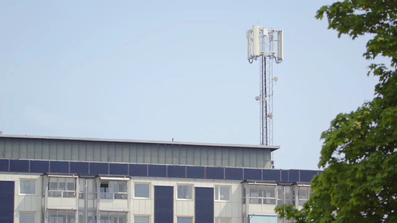 5G mobile phone mast towers above building in telephoto shot Dalarna