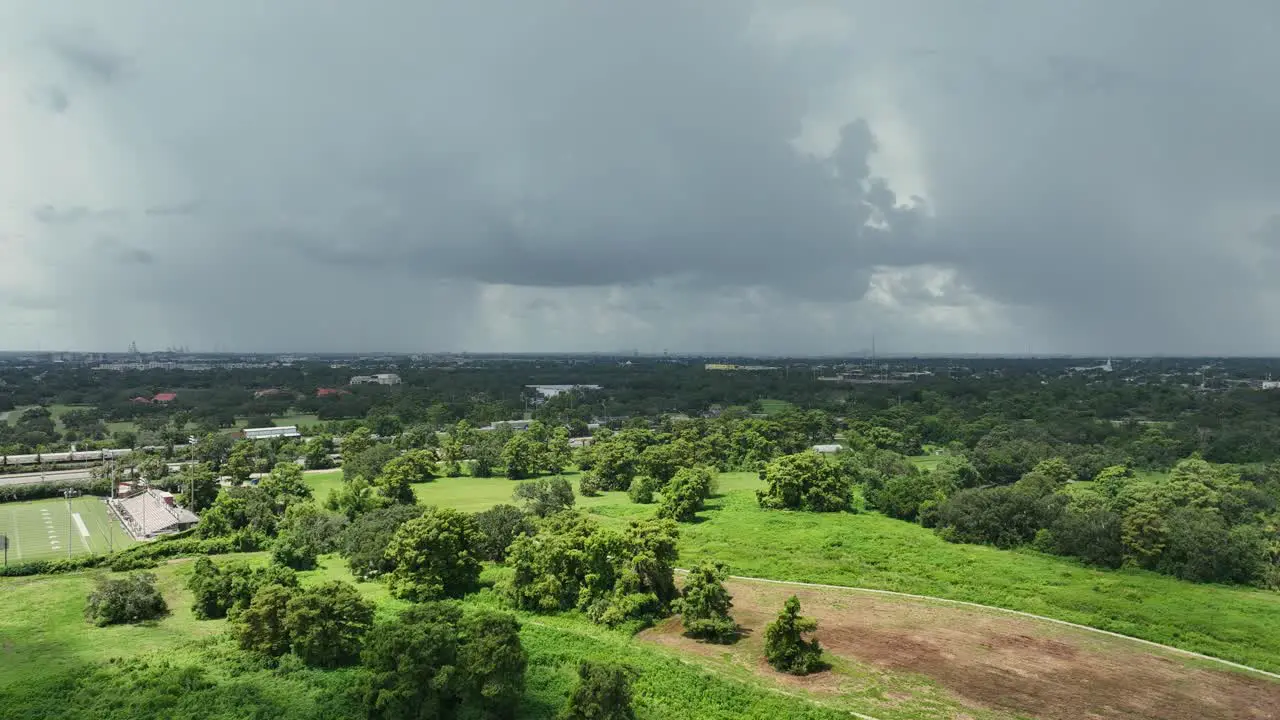 Aerial pan view of rain near City Park in New Orleans