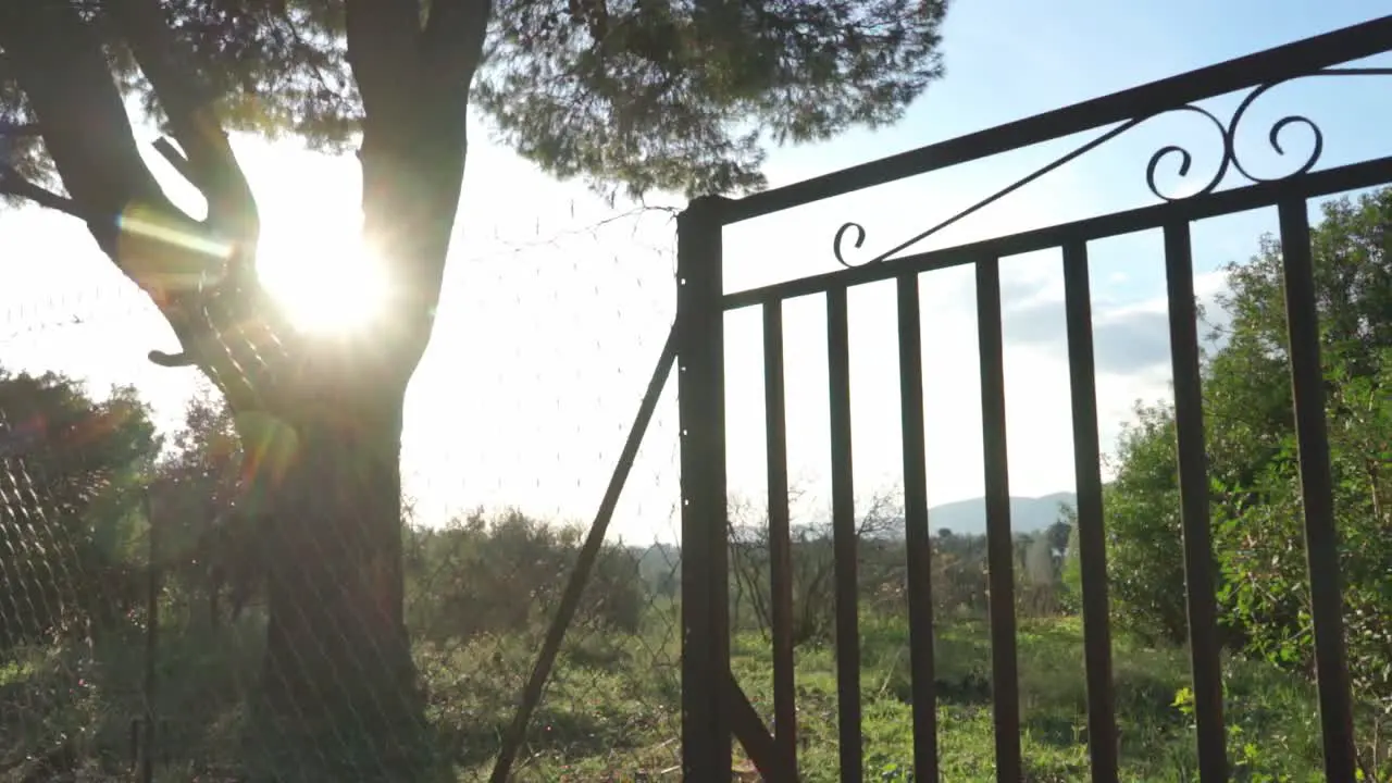 Slide parallax shot of old rusty railing door in the fields with Parnitha mountain on the background