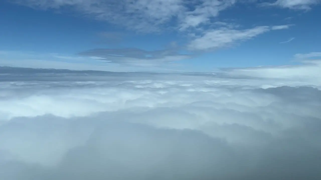 Pilot view overflying a sea of white clouds daylight