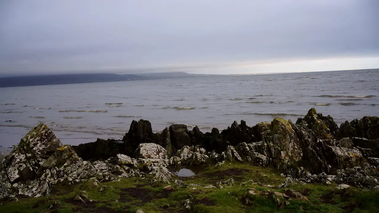 View of sea waves in ocean  green grass and rocks in Dundalk Ireland