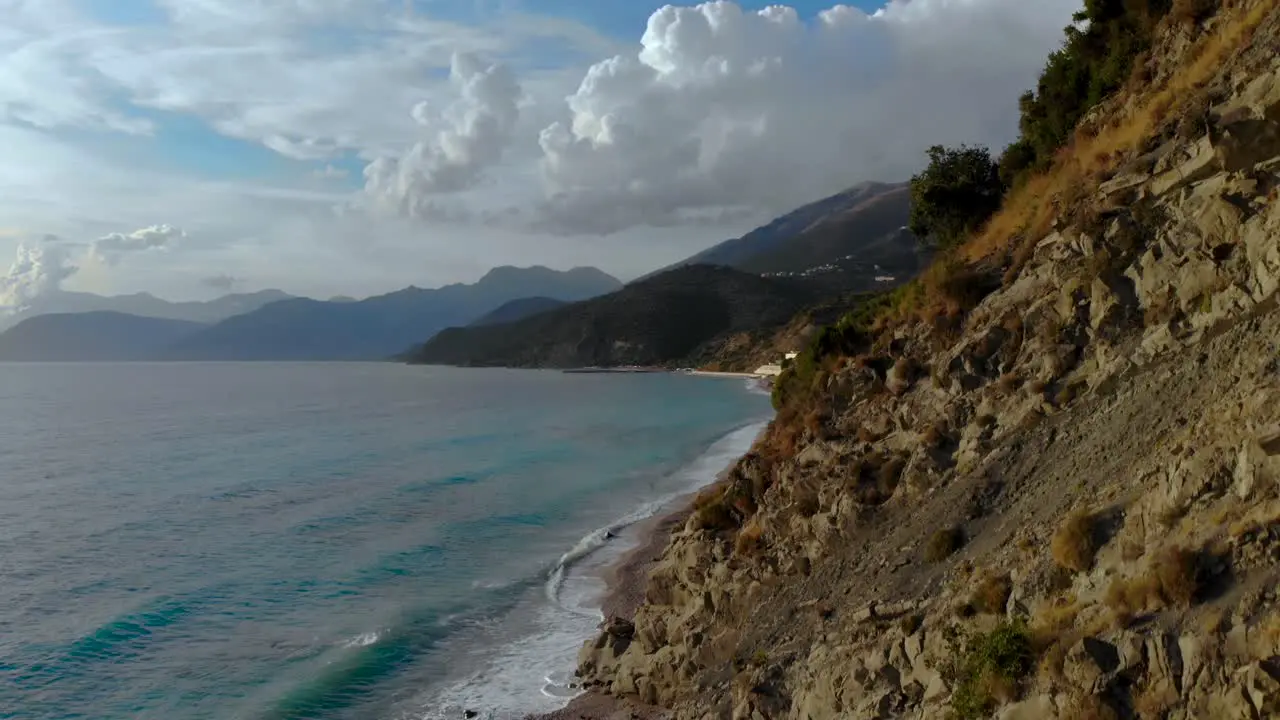 Panoramic seaside with rocky hills on shoreline washed by sea waves on a cloudy day in Mediterranean