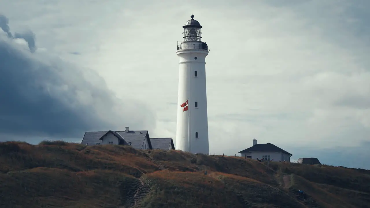 Dark clouds crawl above the lighthouse