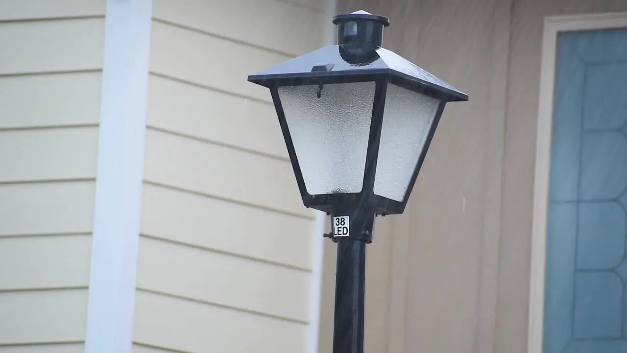 Rain storm hitting street light