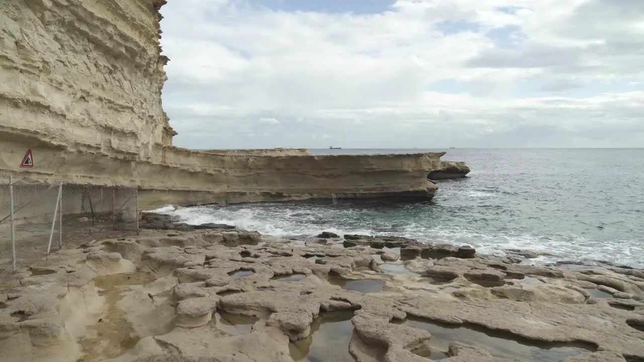 Holes Formed in Stone Ground Filled With Water in St Peter’s Pool Stone Beach in Malta