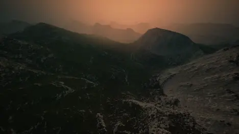 dramatic sky over rocky mountains at sunset