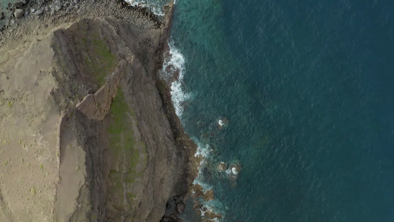 Drone top shot of waves bounce on rocks at the beach