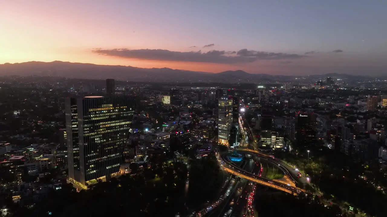 Aerial view of the Virreyes building and the Petroleos Fountain dusk in Mexico city descending drone shot