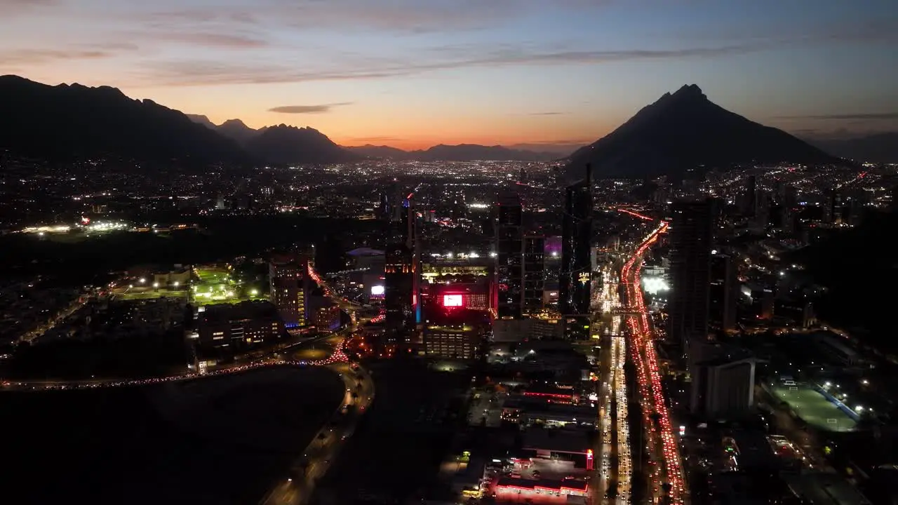 Aerial overview of the illuminated cityscape of San Pedro Garza Garcia Monterrey colorful evening in Mexico