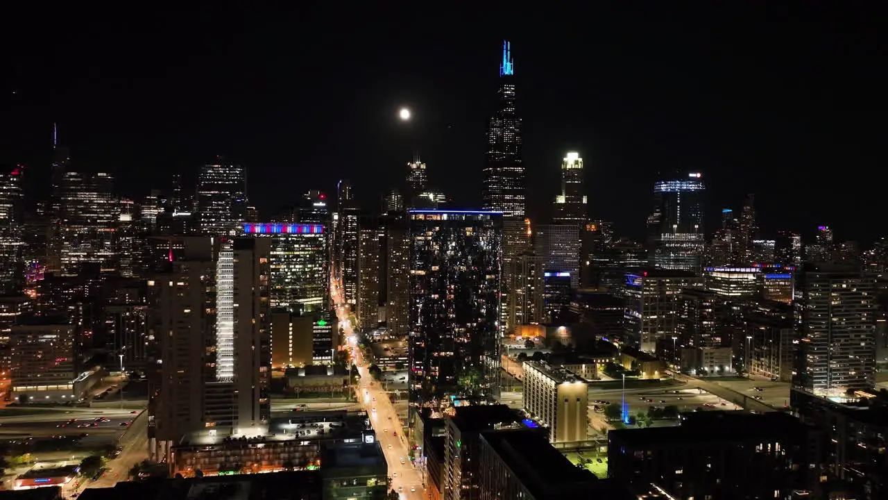 Aerial view following the Monroe street toward West Loop night in Chicago USA