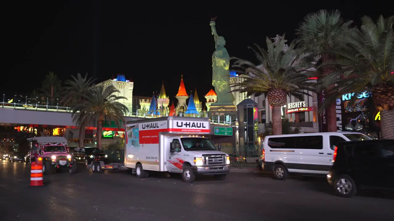 Cars passing Statue of Liberty at Las Vegas strip at night