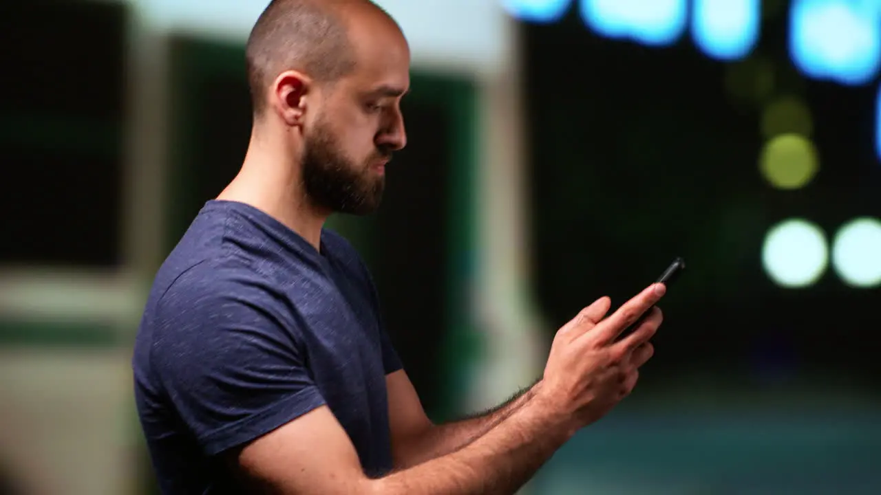 Person uses smartphone on night stroll