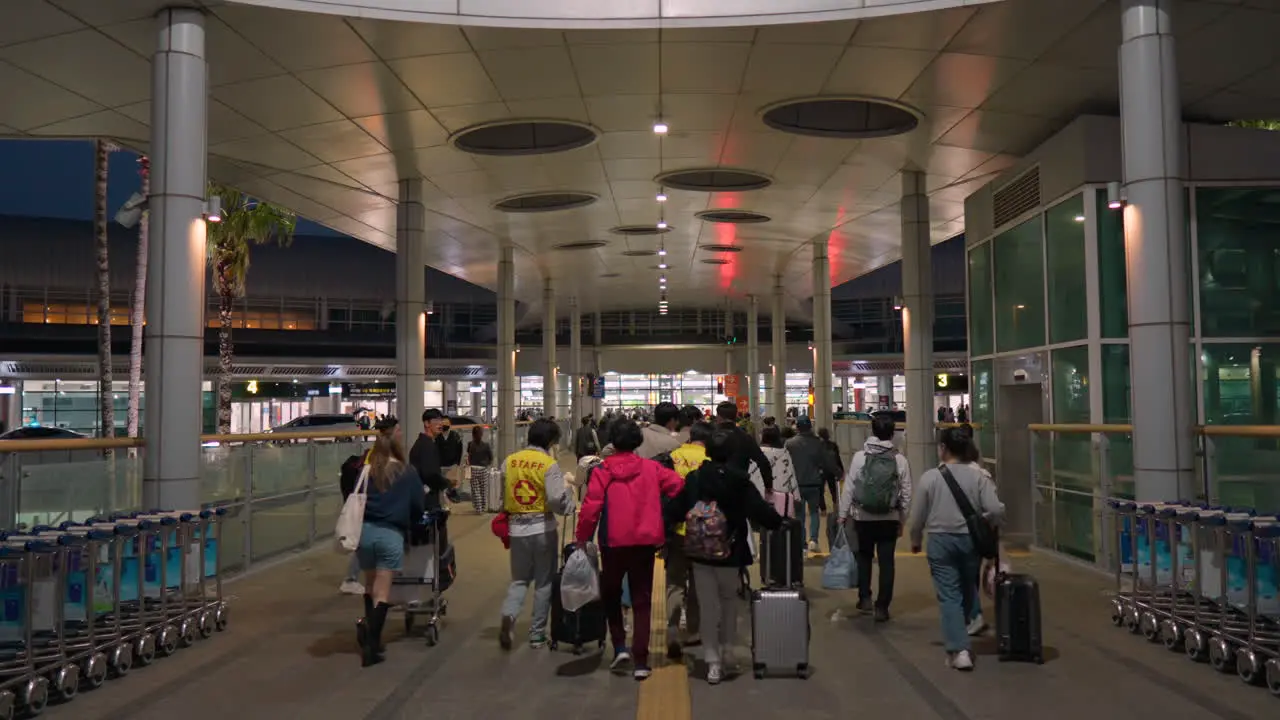 Passengers Walking In The Airport At Night