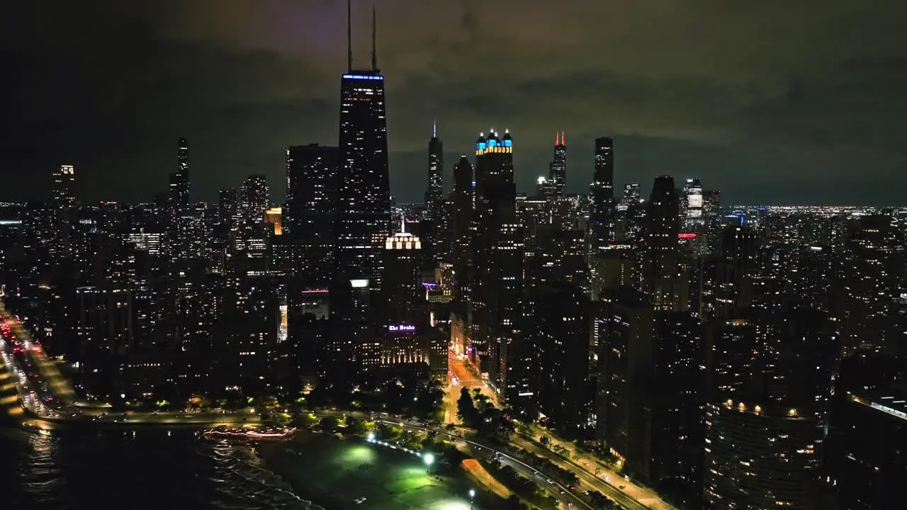 Oak Street Beach and the night lit Chicago Streeterville cityscape Aerial view