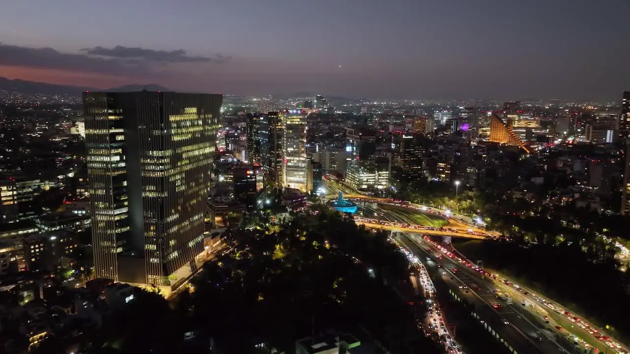 Aerial view approaching the Petroleos Fountain night on Reforma avenue in Mexico city